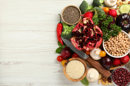 Different vegetables on white wooden table, flat lay and space for text. Vegan dietの写真素材