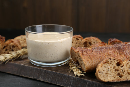 Freshly baked bread, sourdough and spikes on wooden table, closeupの写真素材