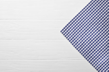 Blue checkered tablecloth on wooden table, top view. Space for textの写真素材