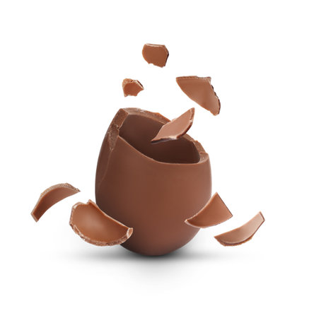Exploded milk chocolate egg on white backgroundの写真素材
