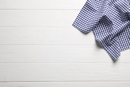 Blue checkered tablecloth on wooden table, top view. Space for textの写真素材