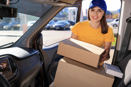 Courier taking parcel from car. Delivery serviceの写真素材