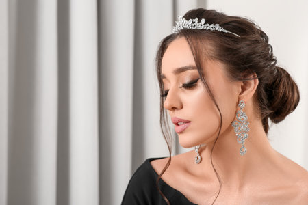 Beautiful young woman wearing luxurious tiara indoors, space for textの写真素材