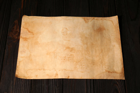Sheet of old parchment paper on wooden table, above viewの写真素材