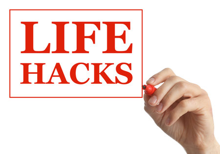 Man framing words Life Hacks with marker on glass board against white background, closeupの写真素材