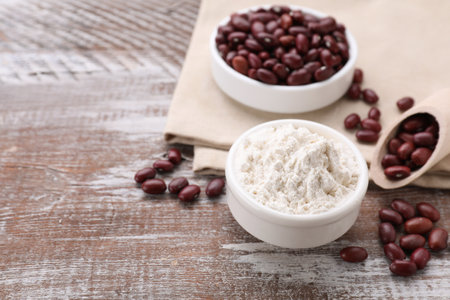 Kidney bean flour and seeds on wooden table. Space for textの写真素材
