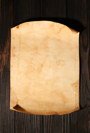 Sheet of old parchment paper on wooden table, top viewの写真素材