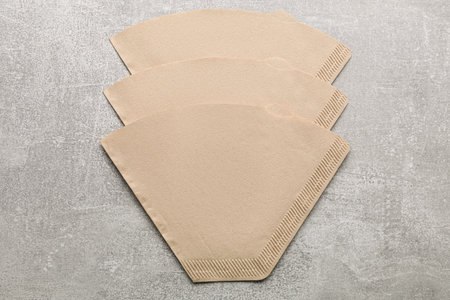 Paper coffee filters on gray table, flat layの写真素材