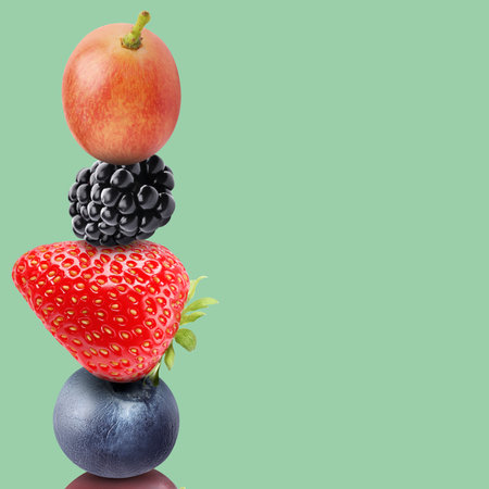 Stack of different fresh tasty berries on pale aquamarine background, space for textの写真素材