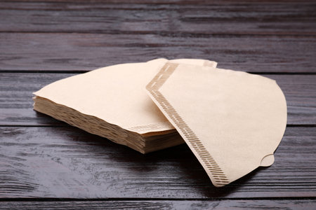 New paper coffee filters on wooden tableの写真素材