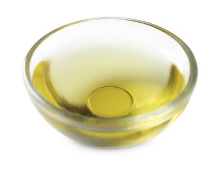 Glass bowl of cooking oil isolated on whiteの写真素材