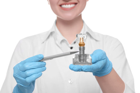 Dentist holding educational model of dental implant on white background, closeupの写真素材