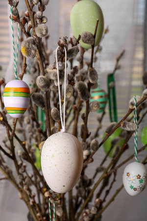 Beautiful willow branches with painted eggs indoors. Easter decorの写真素材