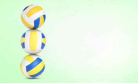 Stack of volleyball balls on pale light green background. Space for textの写真素材
