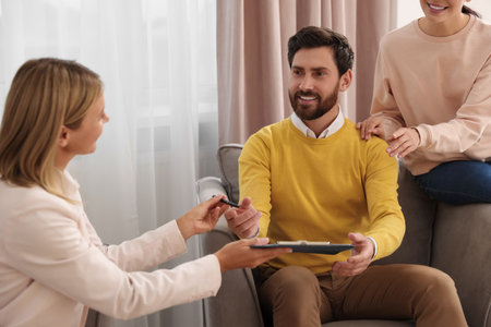 Real estate agent and couple signing contract in new apartment