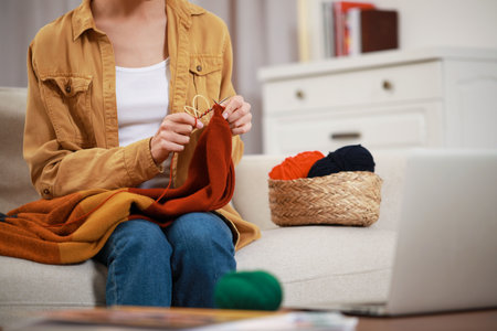 Teacher conducting online knitting course at home, closeup. Time for hobby