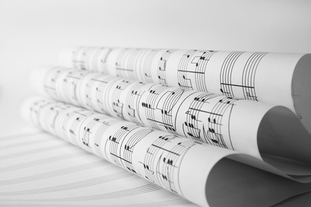 Rolled sheets with music notes on white background, closeupの写真素材