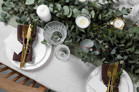 Luxury table setting with beautiful decor and blank cards. Festive dinner