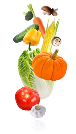 Many different fresh vegetables falling on white backgroundの写真素材