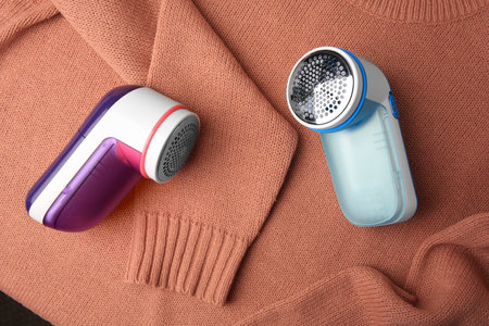 Modern fabric shaver on sweater with lint, flat layの写真素材