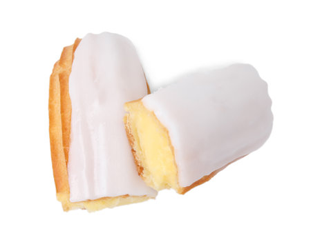 Cut delicious eclair covered with glaze isolated on white, top view