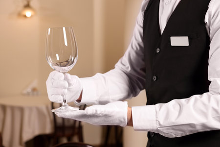 Man setting table in restaurant, closeup. Professional butler coursesの写真素材