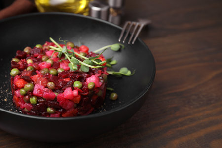 Delicious vinaigrette salad on wooden table, closeup. Space for textの写真素材