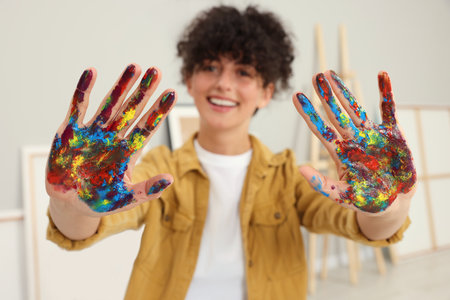 Young woman with painted palms indoors, selective focusの写真素材