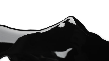 Black glossy paint spilled on white background, top viewの写真素材