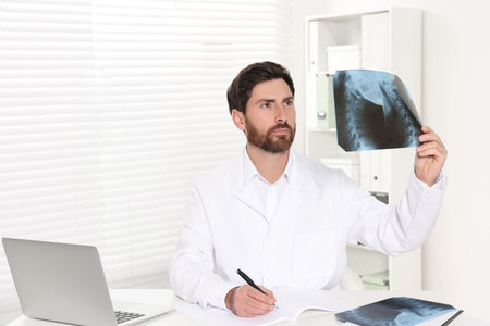 Doctor writing results from MRI scan in hospitalの写真素材