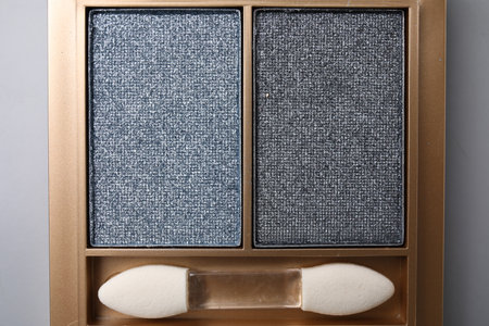 Beautiful eyeshadow palette with applicator on light gray background, top view. professional cosmetic productの写真素材