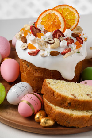 Traditional Easter cake with dried fruits and painted eggs on white table, closeupの写真素材