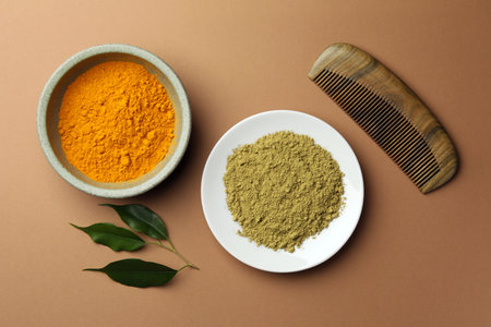 Flat lay composition with henna and turmeric powder on coral background. Natural hair coloring