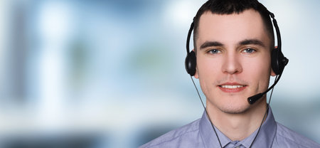 Hotline operator with headset in office, space for text. Banner design