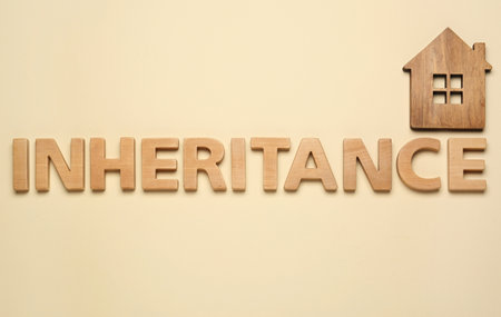 Word Inheritance made with wooden letters and house model on beige background, flat layの写真素材