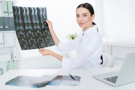 Doctor examining neck MRI image in clinic