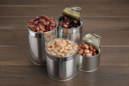 Tin cans with kidney beans on wooden tableの写真素材