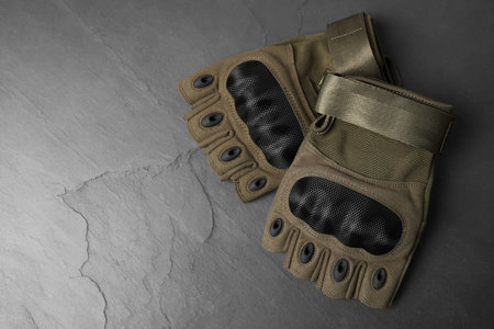 Tactical gloves on gray background, flat lay with space for text. Military training equipmentの写真素材