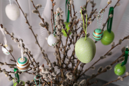 Beautiful willow branches with painted eggs indoors. closeup Easter decor