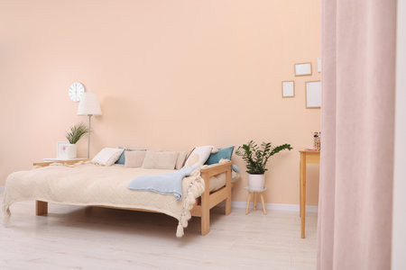 Cozy room interior with comfortable sofa bed. Multifunctional furnitureの写真素材