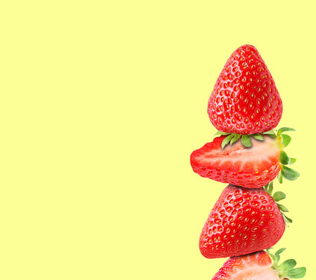 Stack of fresh strawberries on light yellow background, space for textの写真素材