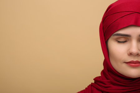 Muslim woman in hijab on beige background, space for textの写真素材