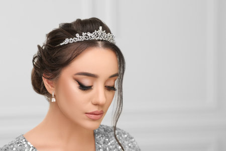 Beautiful young woman wearing luxurious tiara indoors, space for textの写真素材