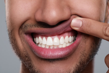 Man showing healthy gums on gray background, closeupの写真素材