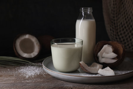 Composition with coconut milk on wooden table, space for textの写真素材