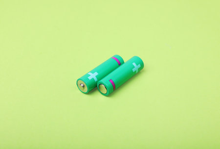 New AA size batteries on light green backgroundの写真素材