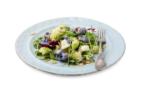 Delicious salad with cauliflower and pumpkin seeds isolated on whiteの写真素材