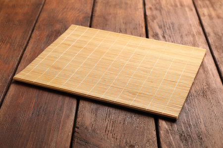 New clean bamboo mat on wooden tableの写真素材