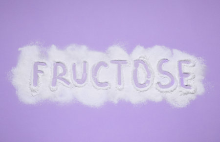 Word Fructose made of powder on violet background, flat layの写真素材