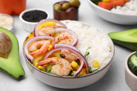 Poke bowl and ingredients on white table, closeup